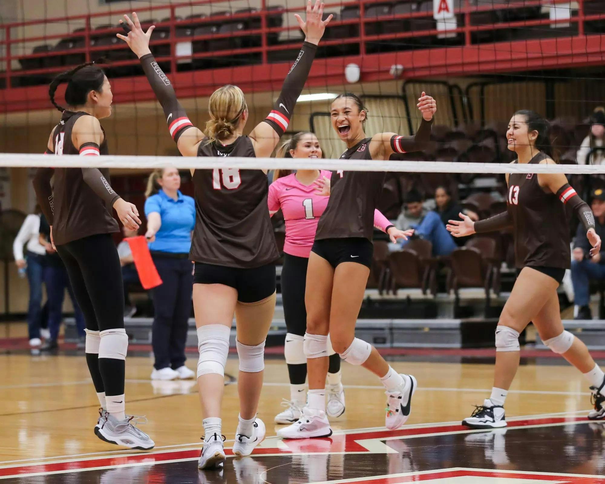 Members of the women's volleyball team cheering
