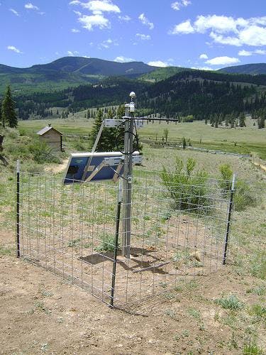 A photo shows a device affiliated with the study situated in a Creede, Colorado plain with mountains in the background. 