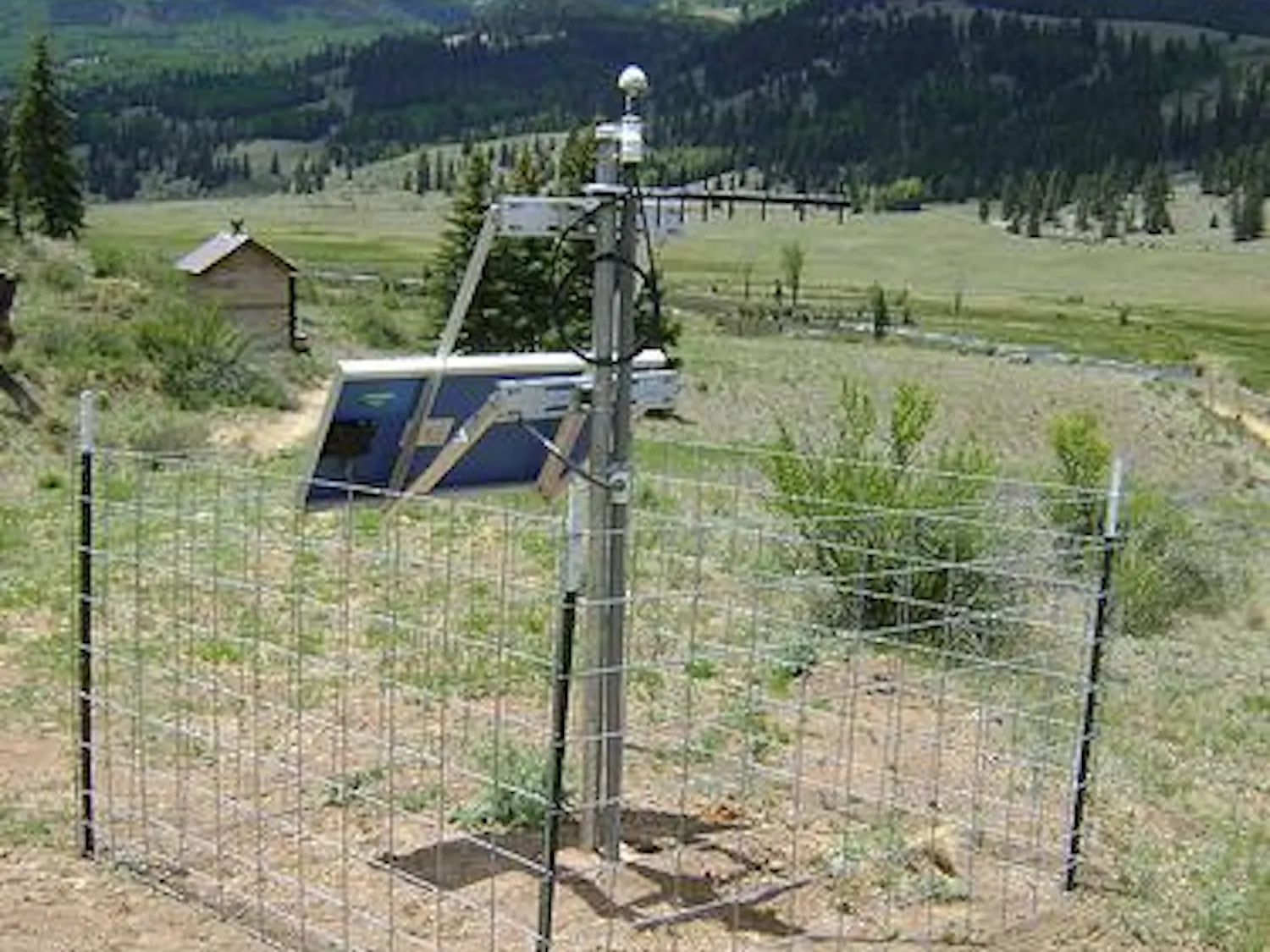 A photo shows a device affiliated with the study situated in a Creede, Colorado plain with mountains in the background.