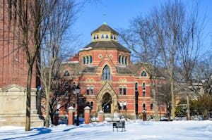 A photo of the economics building from the Quiet Green, covered in snow in February. 
