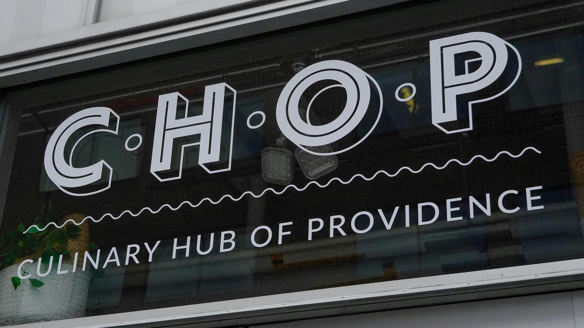 A picture of the CHOP logo on glass. Below the CHOP letters, the letters read "Culinary Hub of Providence."
