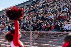 A photo of the crowd with Brown team cheerleaders in the foreground.
