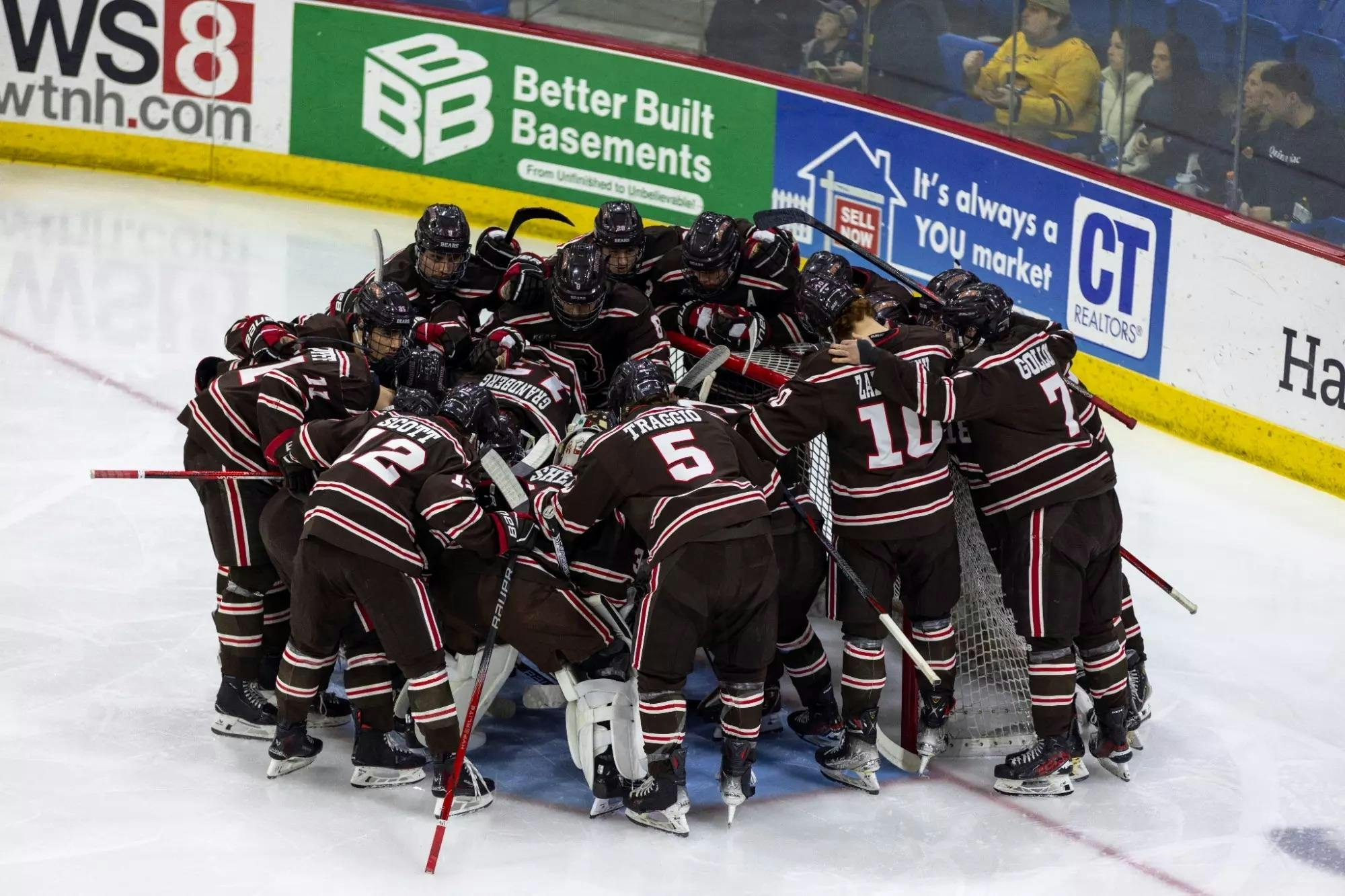 A picture of Brown hockey players huddled together on the ice.