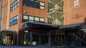 A photograph of Page-Robinson Hall, a brick building with a glass entrance/windows.