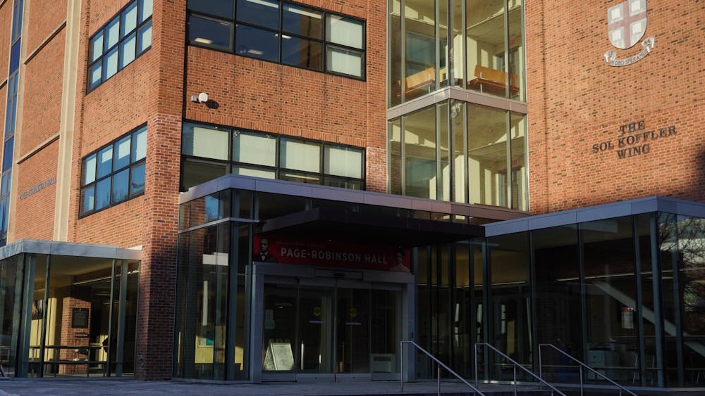A photograph of Page-Robinson Hall, a brick building with a glass entrance/windows.