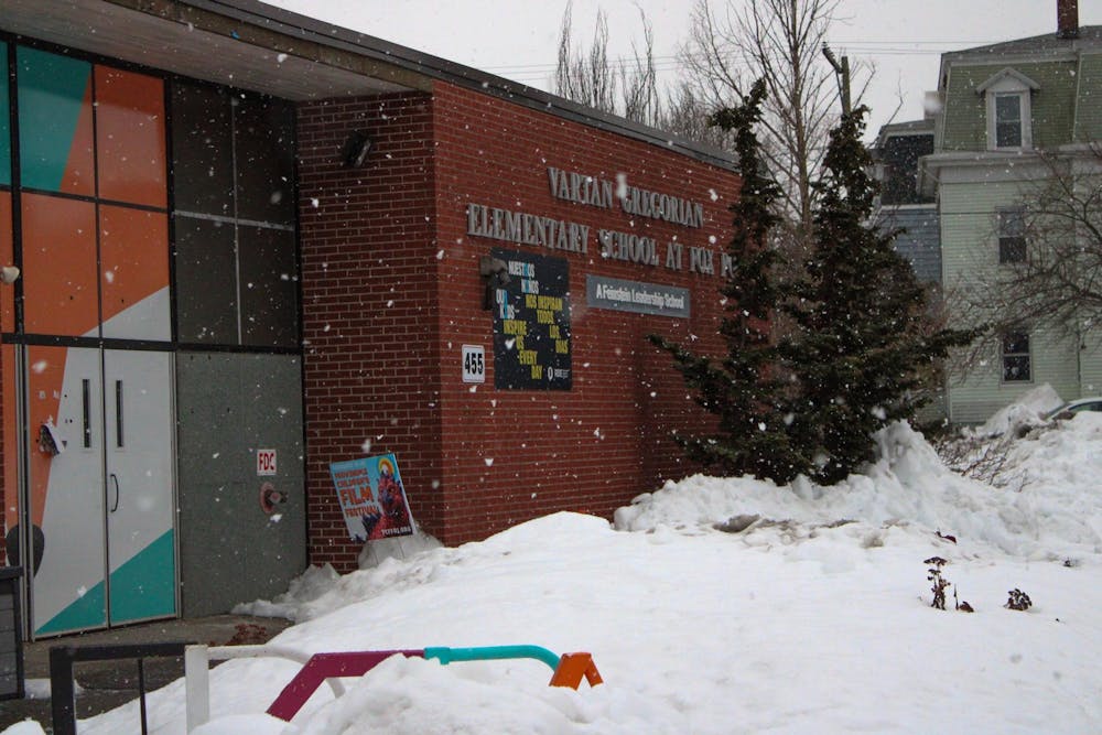 Photo of the Vartan Gregorian Elementary School covered in falling snow.