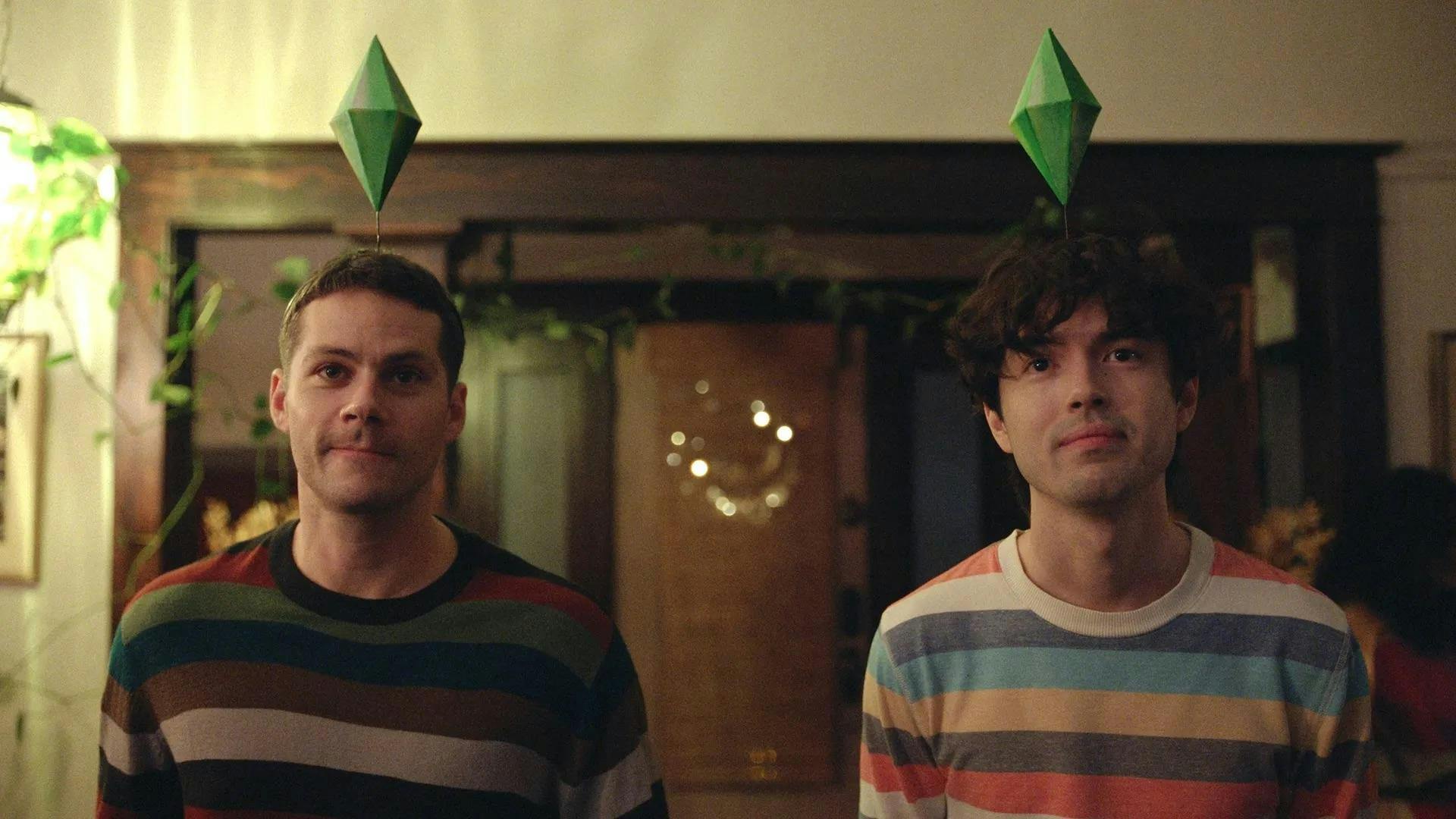 A photo of two men facing the camera, both wearing striped shirts with green diamond-shaped symbols above their heads. 