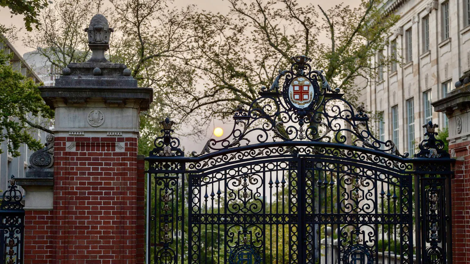 Photo of the Van Wickle gates with the sun setting in the background