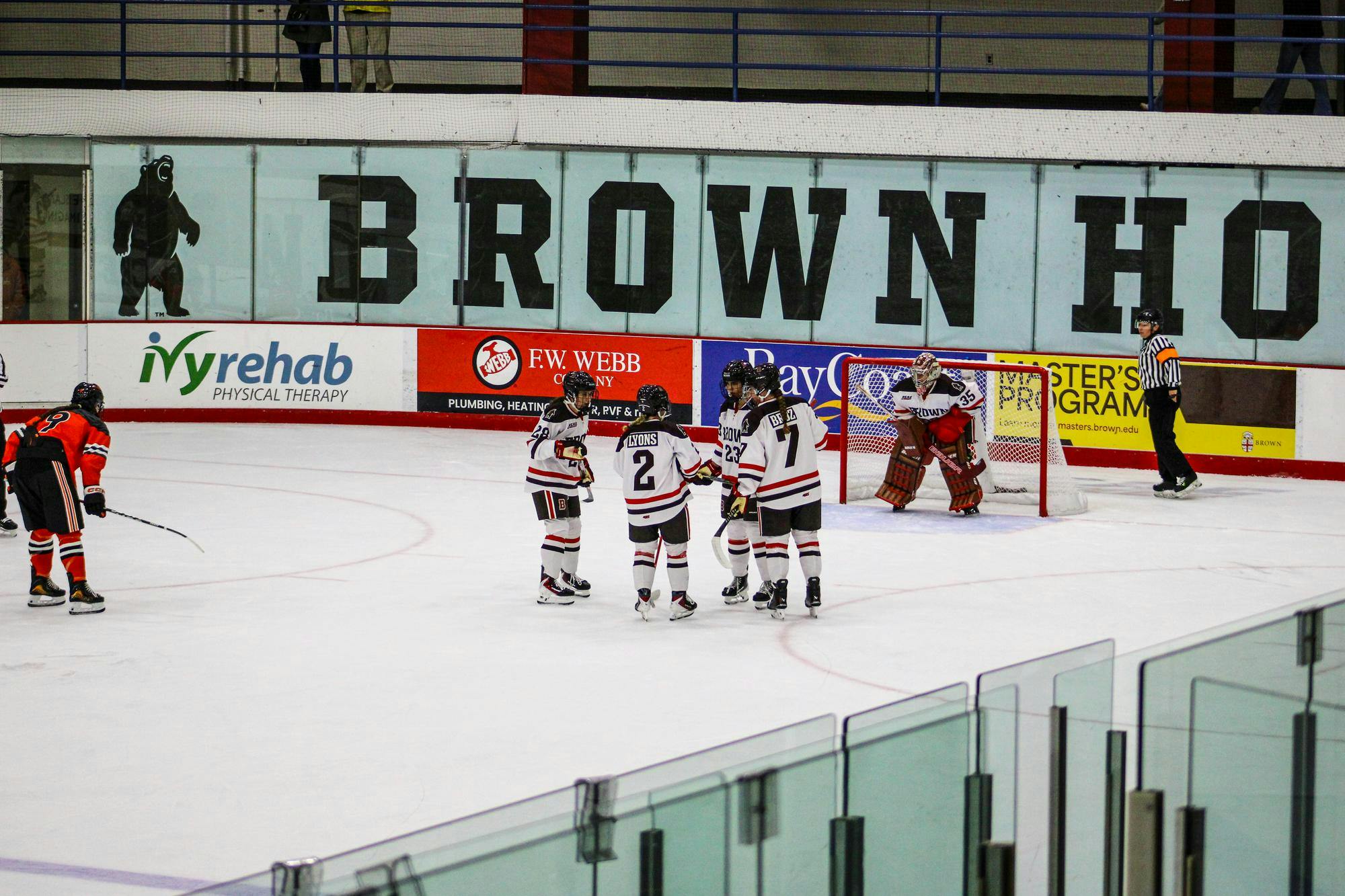 Monique Lyons ’28, Sam Broz ’27, Cadence Richards ’29, Victoria Damiani ’28 huddle in preparation for a defensive-zone faceoff.