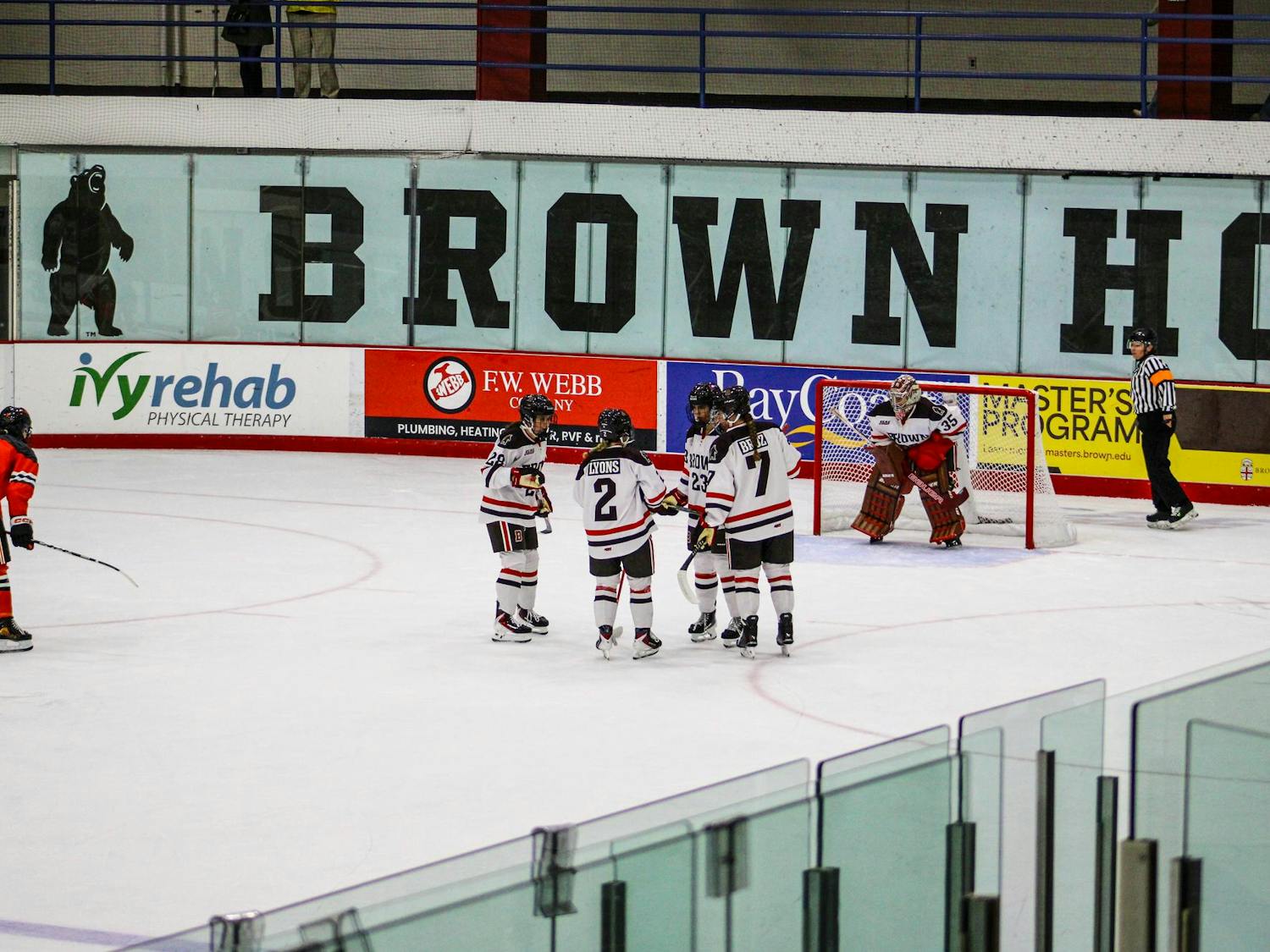 Monique Lyons ’28, Sam Broz ’27, Cadence Richards ’29, Victoria Damiani ’28 huddle in preparation for a defensive-zone faceoff.