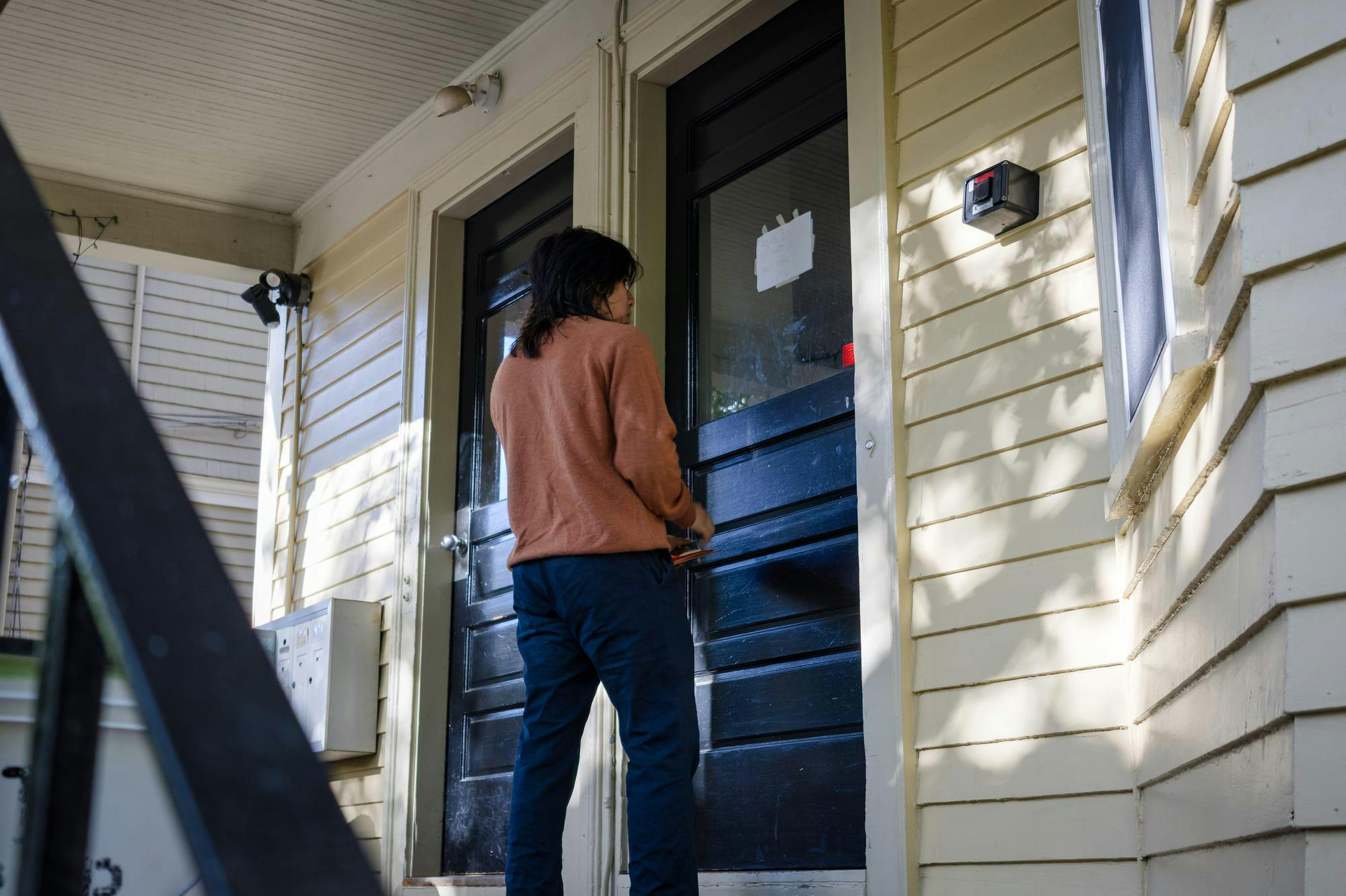 Photo of Axel Brito waiting outside a door in College Hill.