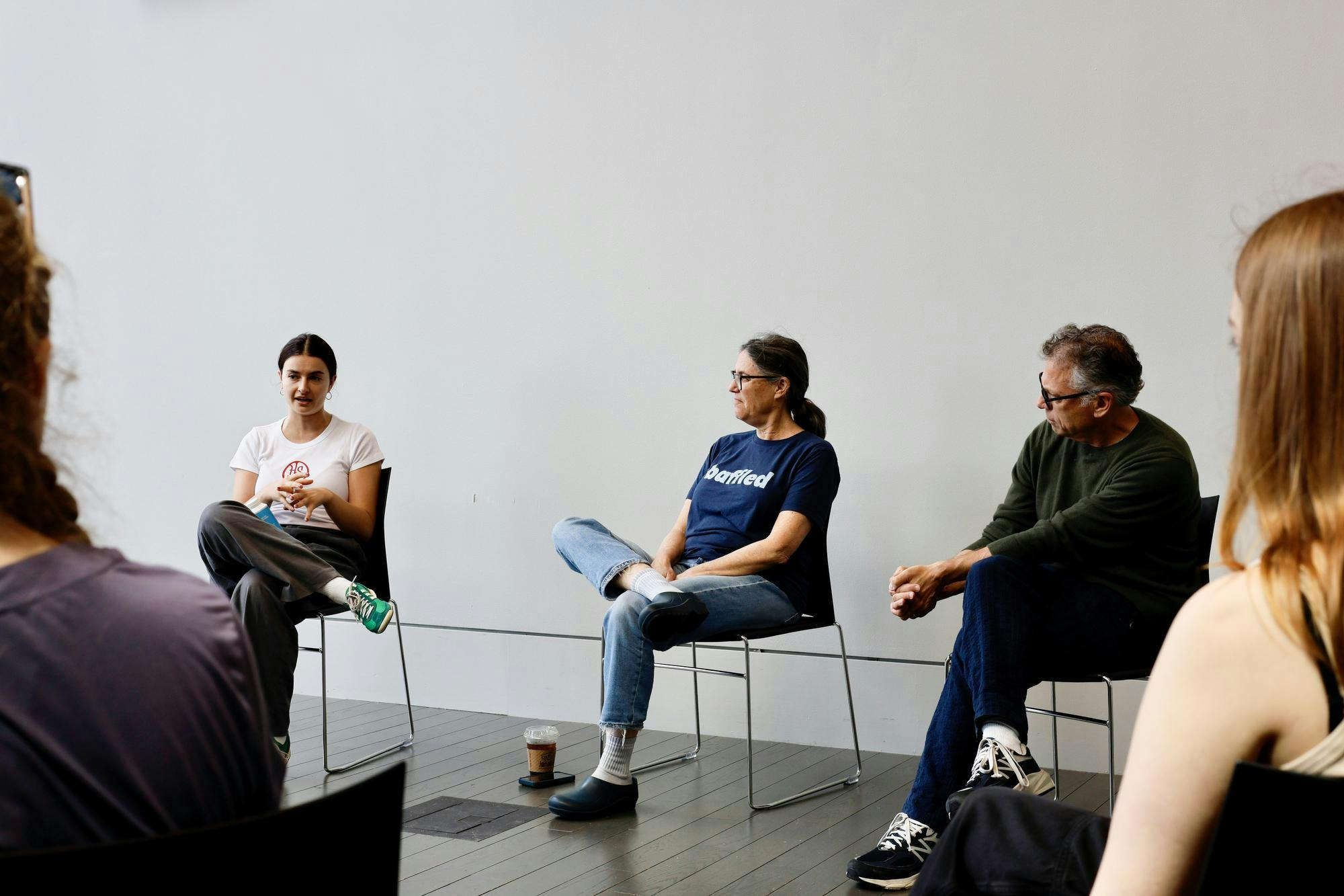 A photo of Talia Light Rake speaking. She is sitting next to two other individuals.