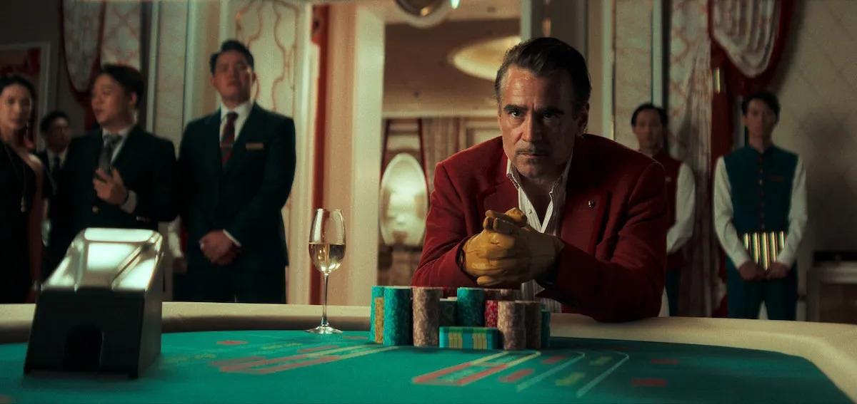 Still from the film with a man staring across a poker table