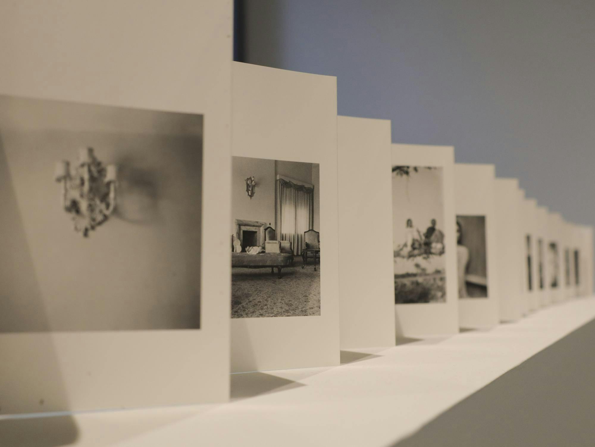 A photo of many cards in a row with black-and-white photos on each card.