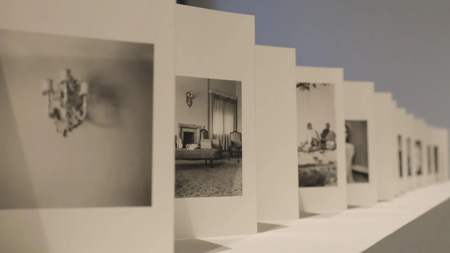 A photo of many cards in a row with black-and-white photos on each card.
