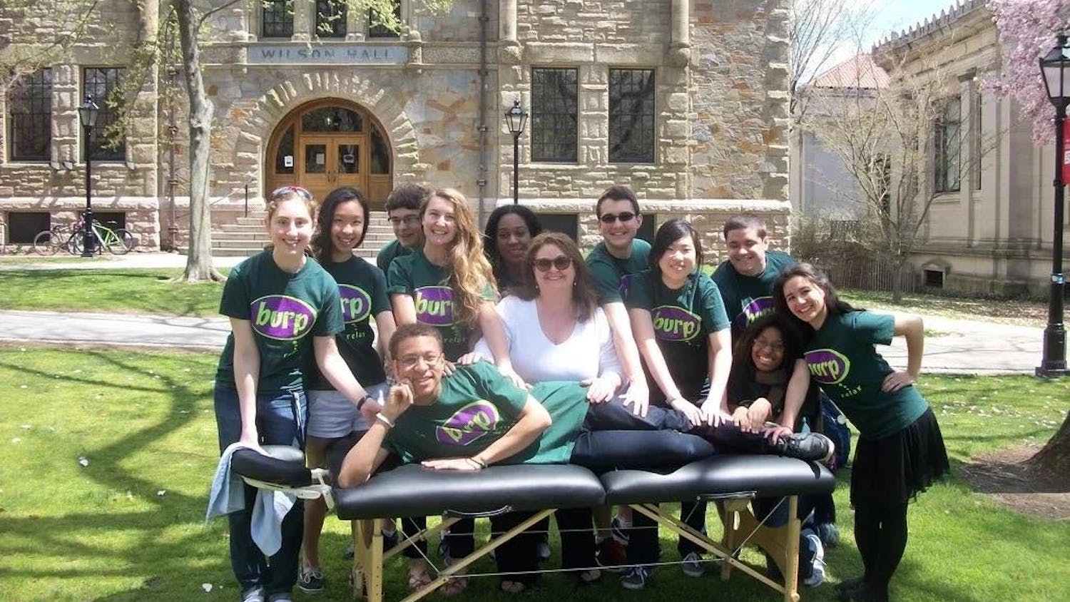 Members of BURP posing with a massage table on the Main Green