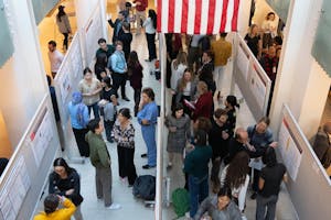 A look down at the symposium with people in between poster boards.