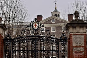 Photo of University Hall through Van Wickle Gates against a grey, cloudy sky.