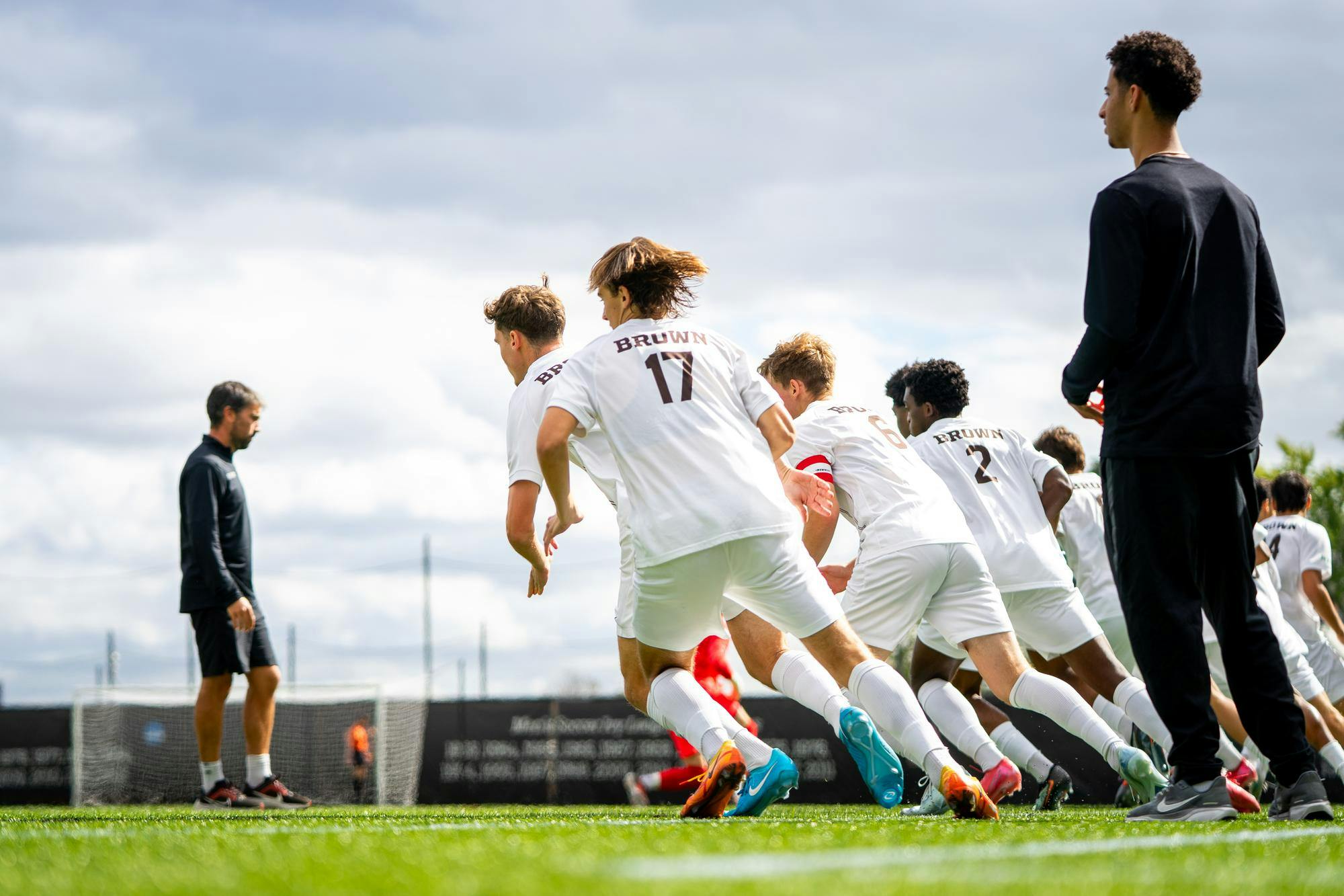 Photo of the Brown men's soccer team warming up on the pitch on Saturday.