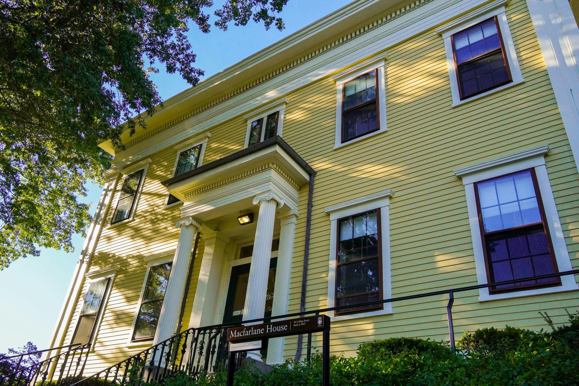 A yellow house, labeled "Macfarlane House." 