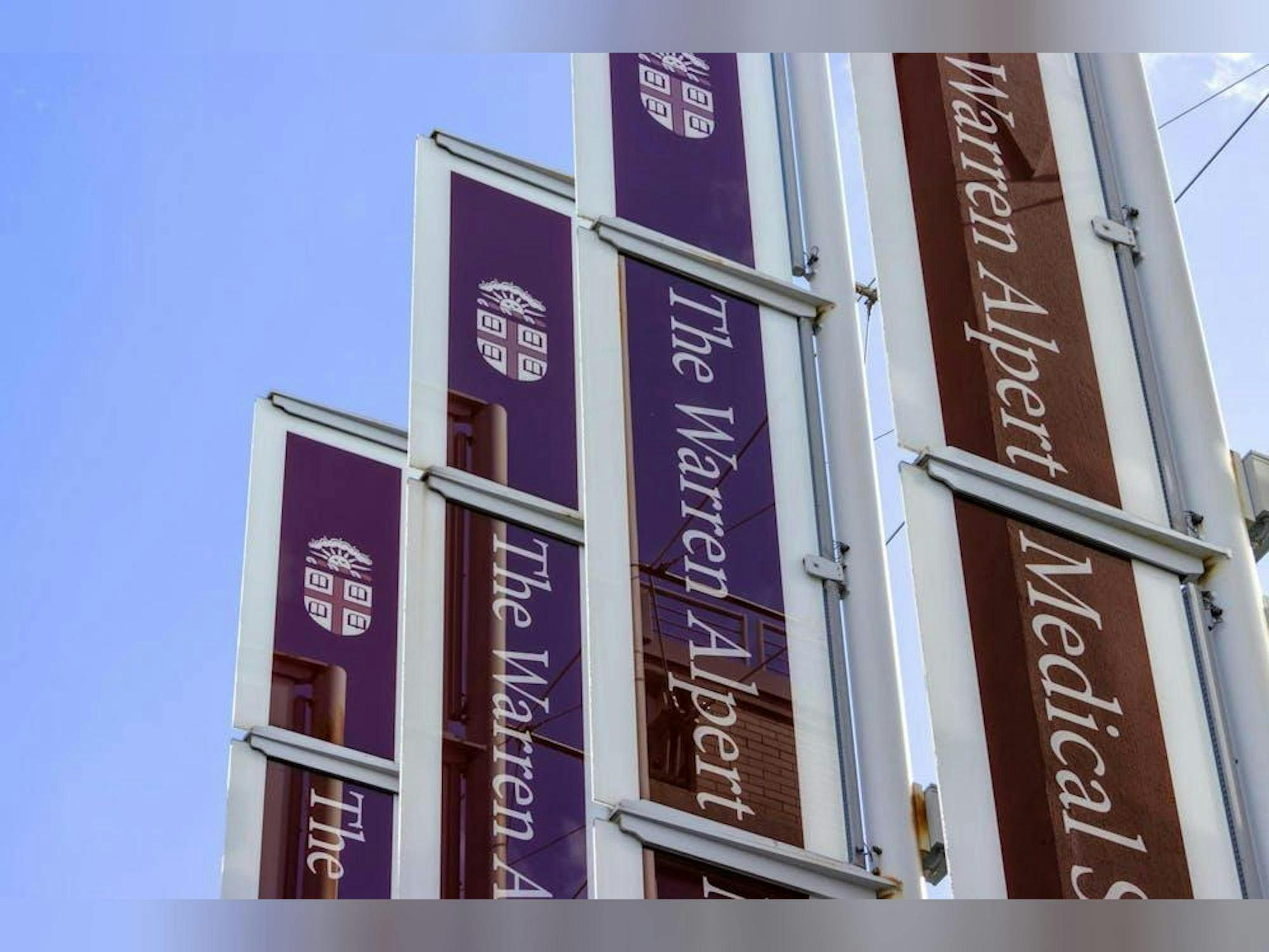 A photo of four vertical signs reading Warren Alpert Medical school.  