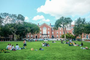 Bright image of students hanging out not he main green in front of the student center.