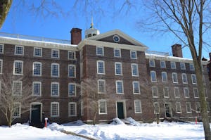 University Hall with a snow-covered yard and bare trees in the front.
