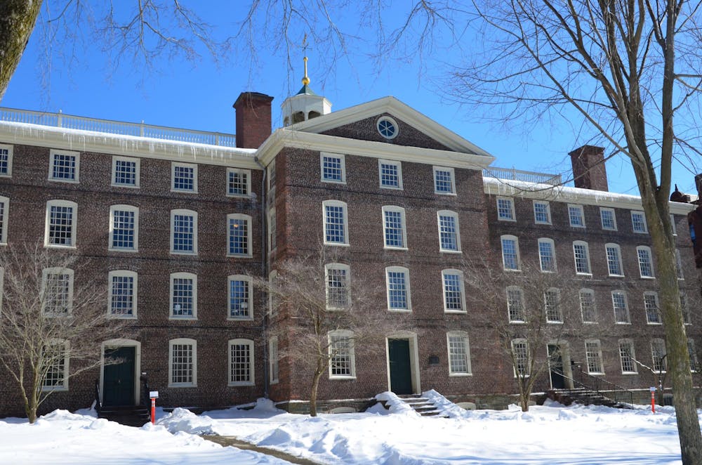 University Hall with a snow-covered yard and bare trees in the front.