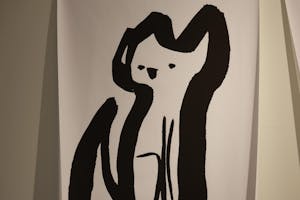 Photo of a large, bold and stylized black-and-white cat drawing, with a bold border around the cat's body.