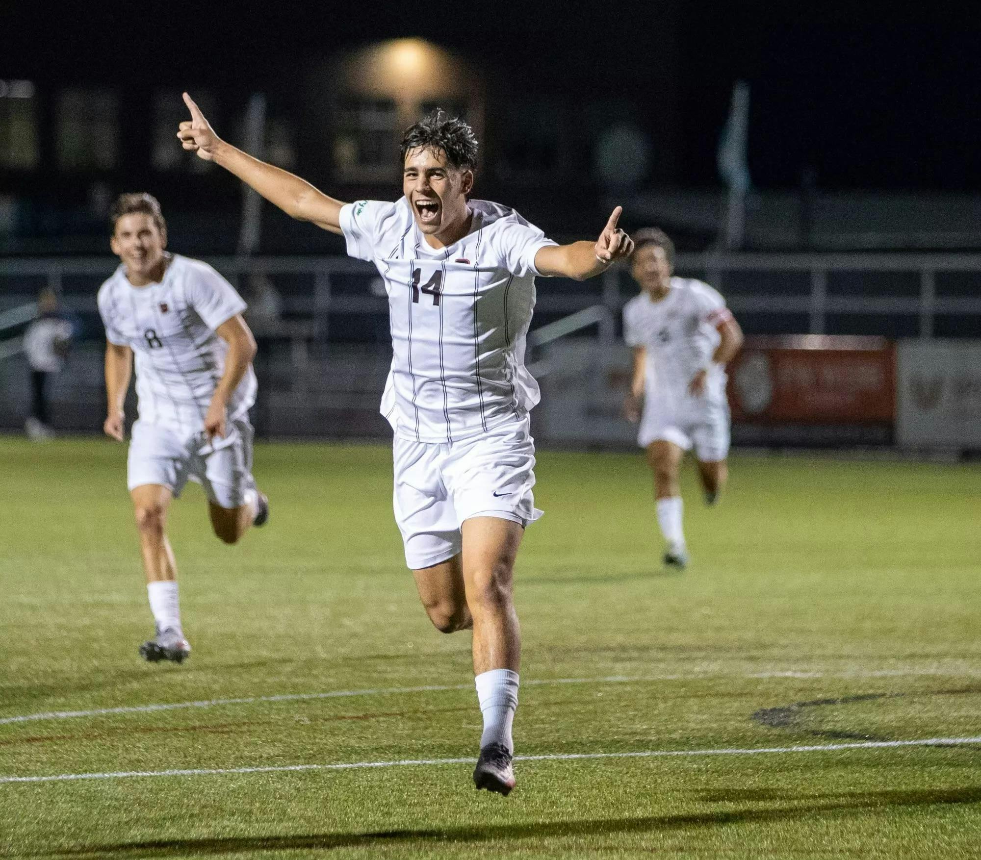 A player celebrating with fingers pointing up.