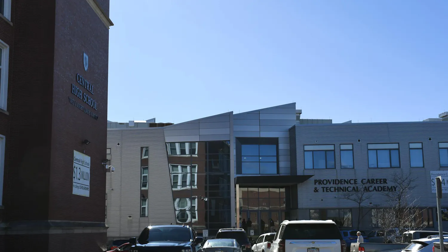 A photo showing the outside of Providence Career and Technical Academy to the right of Central High School during a sunny day.