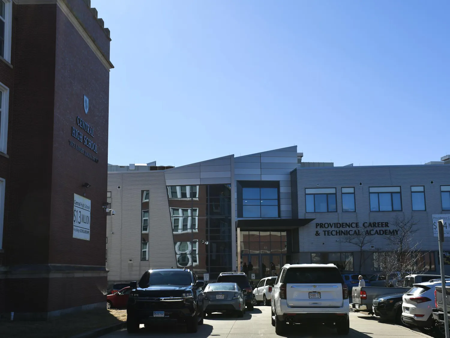 A photo showing the outside of Providence Career and Technical Academy to the right of Central High School during a sunny day.