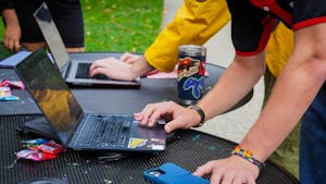 A zoom-in shot of hands clicking on a laptop. 