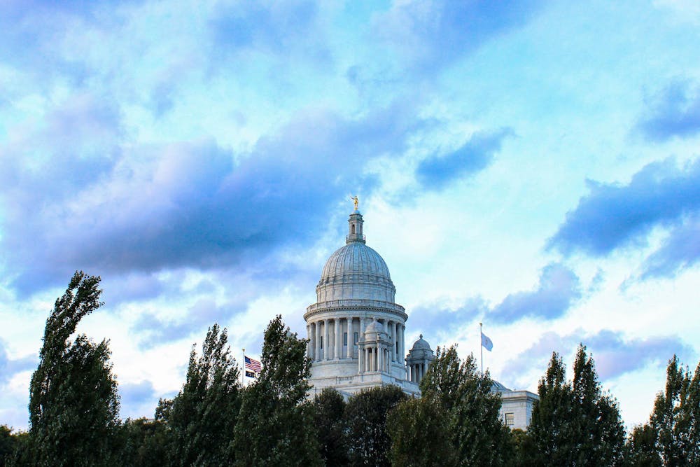 A photo of the Rhode Island Statehouse above trees.