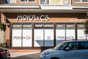 Photo of the new Moka & Co. location on Angell St. with windows papered over and its logo and “BREWING SOON” text on top.
