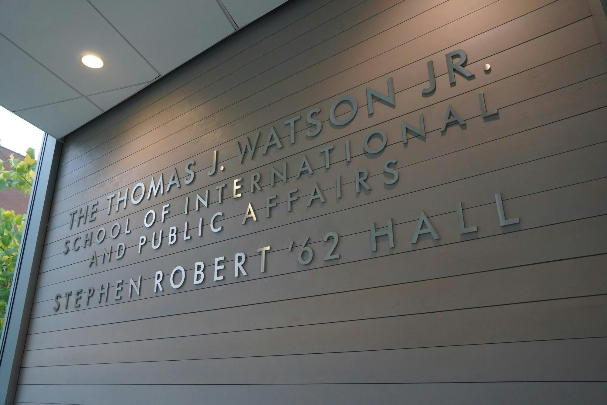 Photo of a wall with silver letters saying “The Thomas J. Watson Jr. School of International and Public Affairs Stephen Robert ’62 Hall” in all capital letters.