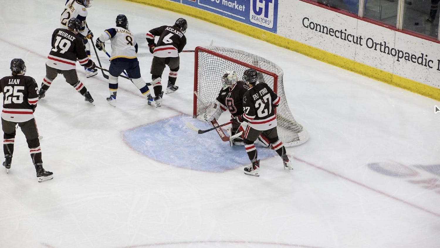 Photo of the Brown women’s hockey team defending their goal against Quinnipiac.