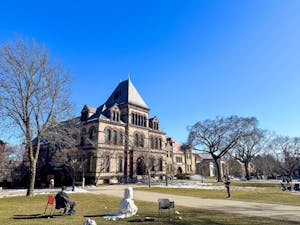 Photo of Sayles Hall and the Main Green on a sunny day.

