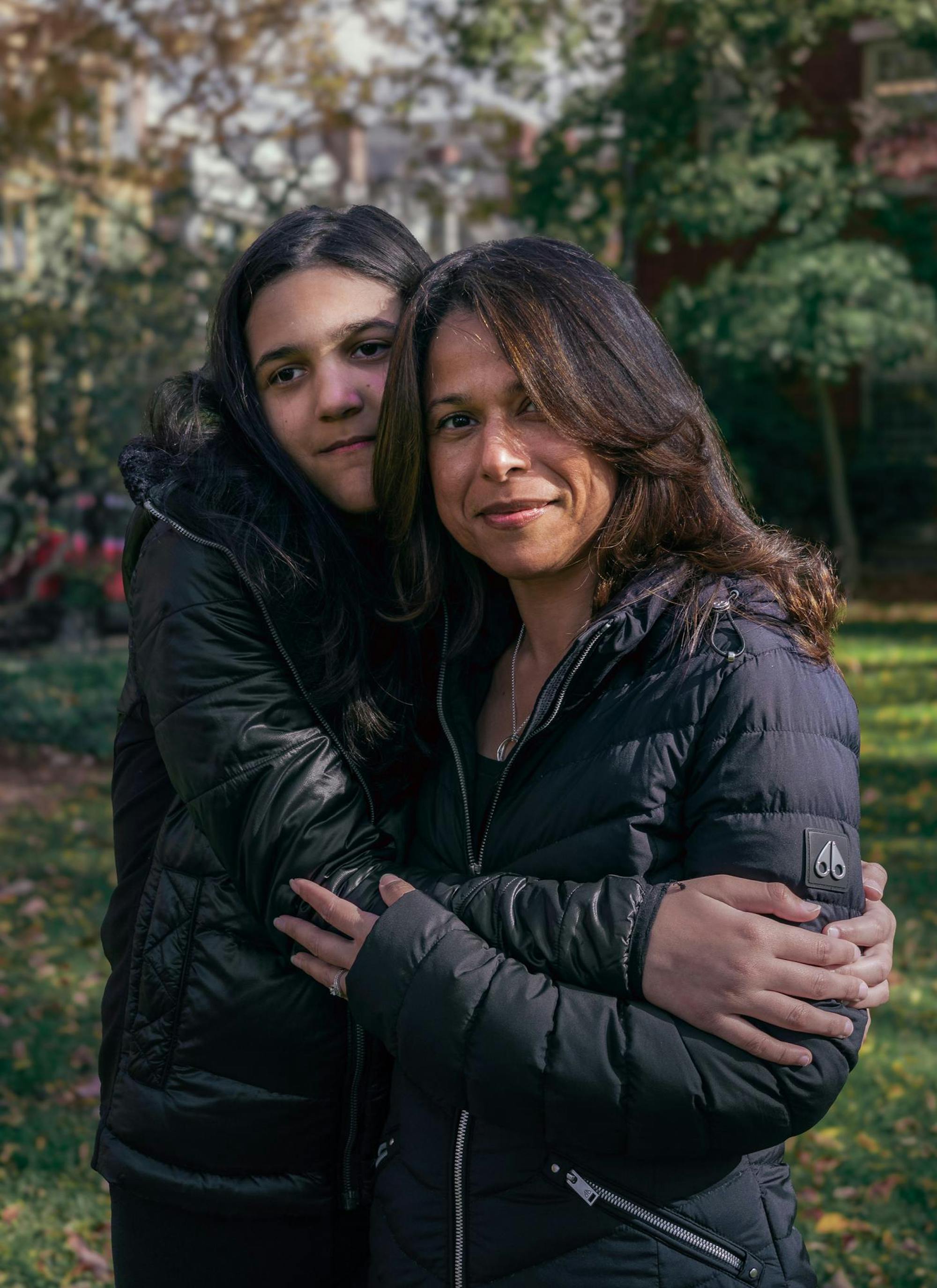 Photo of a mother and her child looking into the camera.