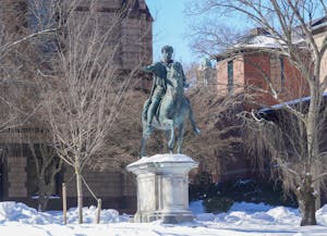 Photo of the Marcus Aurelius statue atop of the hill on Ruth J. Simmons Quadrangle with a layer of snow on the ground.