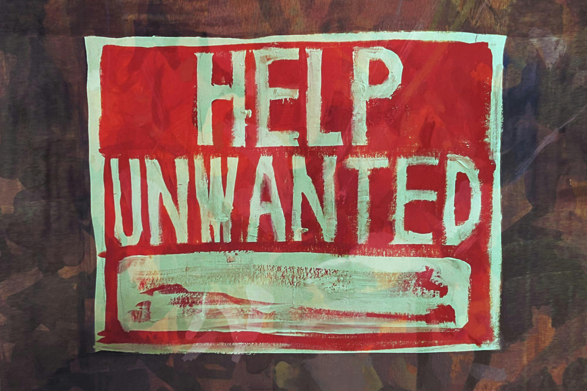 A red "Help Unwanted" sign against a brown-washed background.