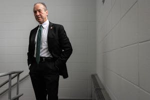 Photo of Hugh Clements in a black suit.

