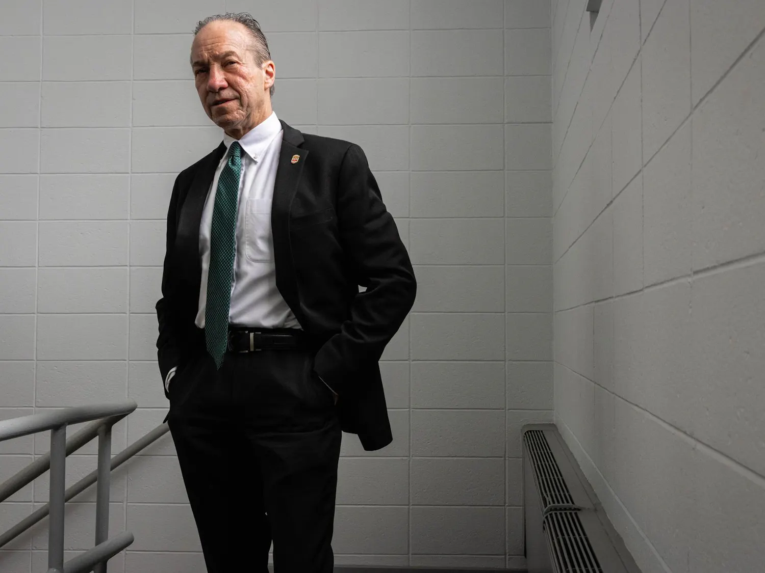 Photo of Hugh Clements in a black suit.