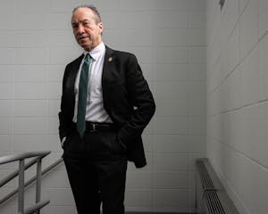 Photo of Hugh Clements in a black suit.