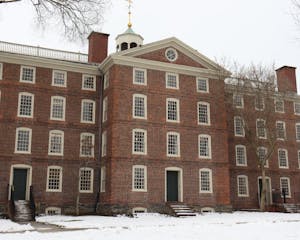 University Hall in the winter with multiple bare trees and snow in the front.