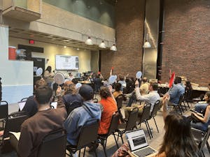 Graduate students vote for candidates at the May Graduate Student Council meeting.