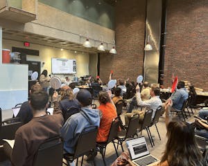 Graduate students vote for candidates at the May Graduate Student Council meeting.
