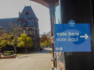 A "vote here" poster on Faunce Arch.