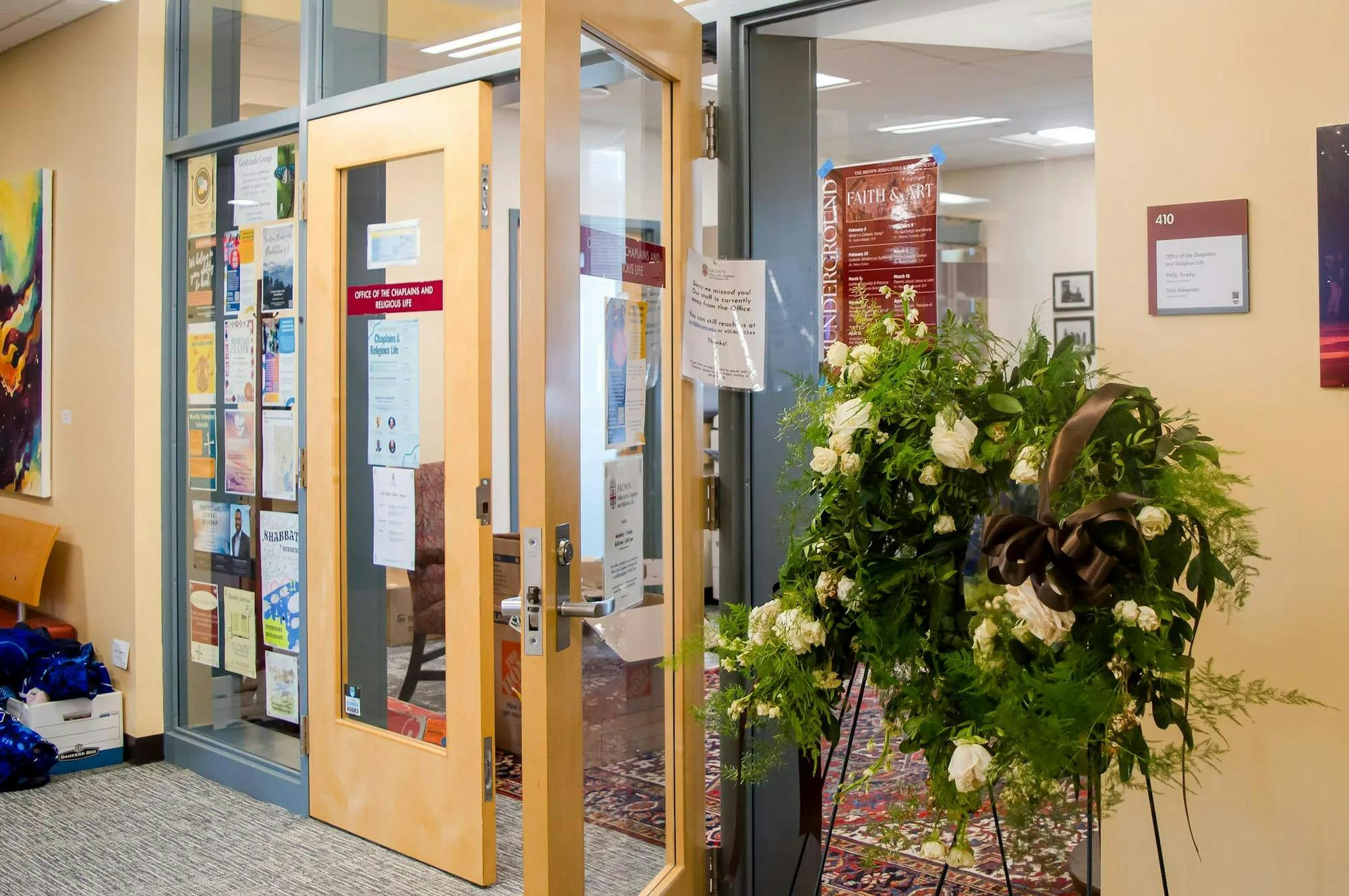 A photo of the entrance of the Office of the Chaplains and Religious Life, with a display of flowers to the right of the frame.
