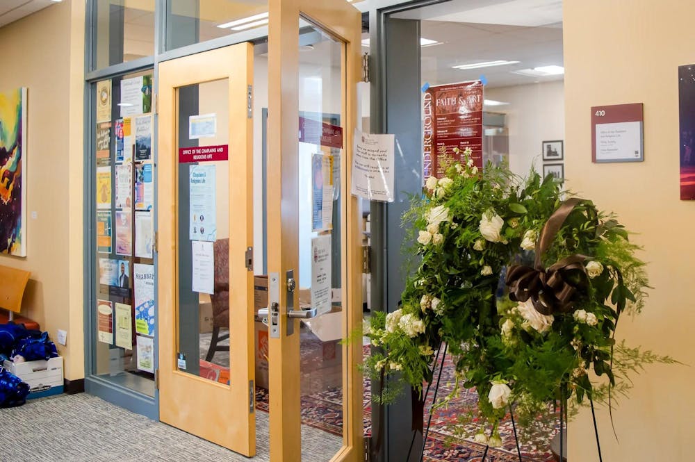A photo of the entrance of the Office of the Chaplains and Religious Life, with a display of flowers to the right of the frame.
